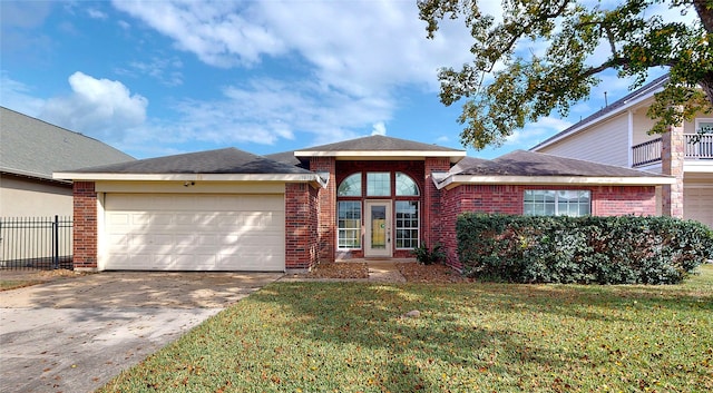 view of front facade with a front yard and a garage