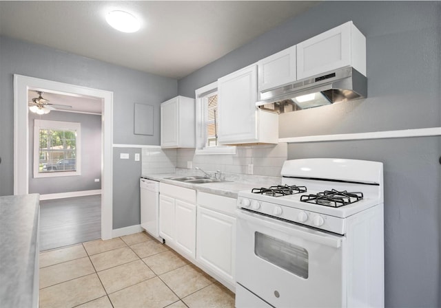 kitchen featuring white cabinetry, sink, white appliances, and ventilation hood