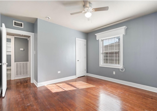 unfurnished room with dark hardwood / wood-style flooring and ceiling fan