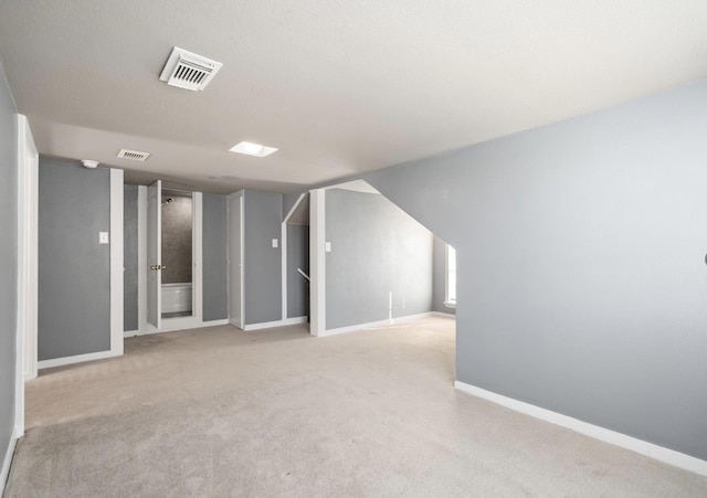 basement featuring light colored carpet