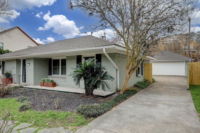 ranch-style house featuring a garage and an outbuilding