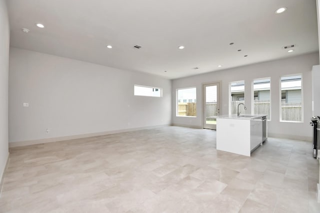 kitchen featuring sink and a center island with sink