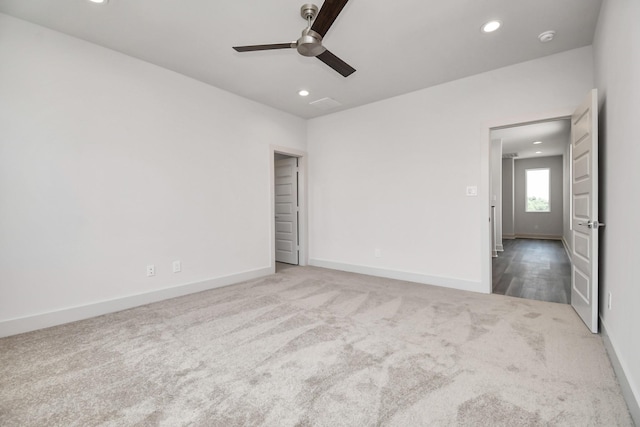 carpeted empty room featuring ceiling fan