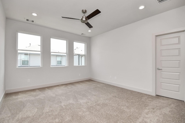 carpeted spare room featuring ceiling fan