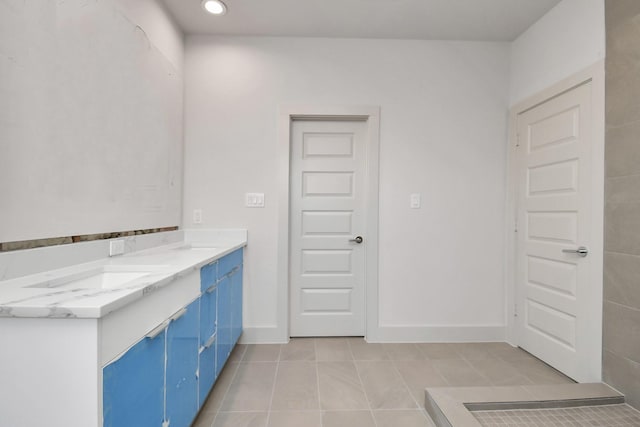 bathroom featuring tile patterned flooring and vanity