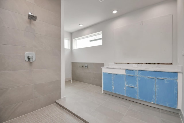 bathroom with tile patterned floors and a tile shower