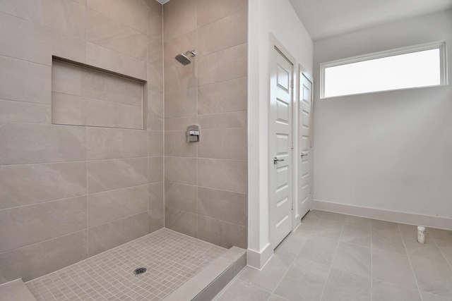 bathroom featuring tiled shower and tile patterned floors