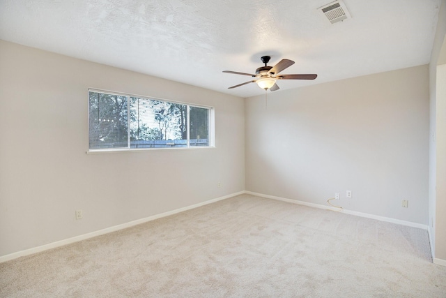 unfurnished room featuring light carpet and ceiling fan