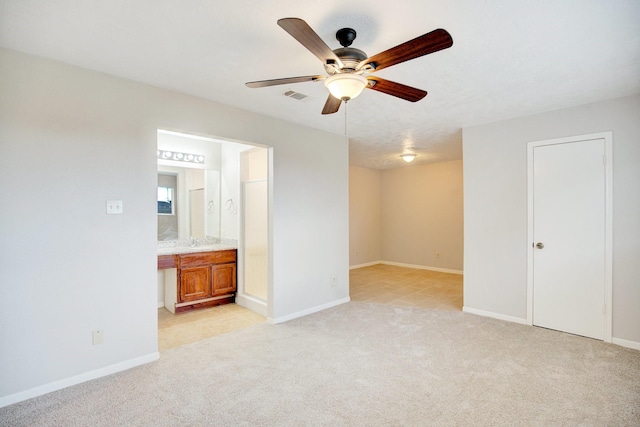 spare room featuring ceiling fan and light colored carpet