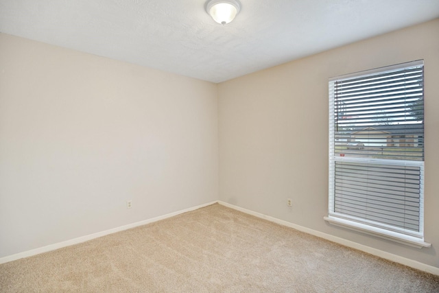 unfurnished room with light colored carpet