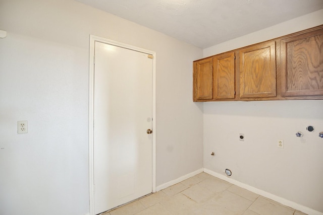 clothes washing area featuring cabinets, electric dryer hookup, gas dryer hookup, and washer hookup