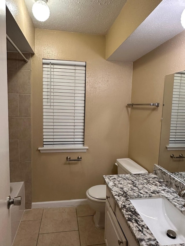 full bathroom with tile patterned floors, vanity, a textured ceiling, shower / washtub combination, and toilet