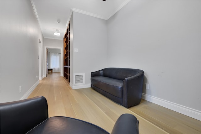 interior space featuring ornamental molding and light hardwood / wood-style flooring