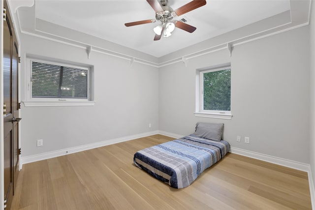 bedroom with ceiling fan and wood-type flooring