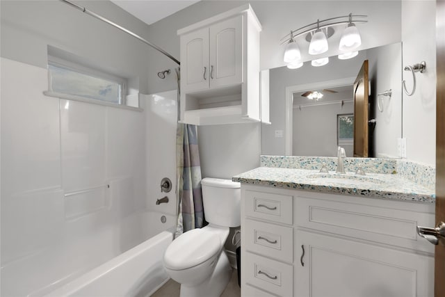 full bathroom with vanity, shower / bath combo, and toilet