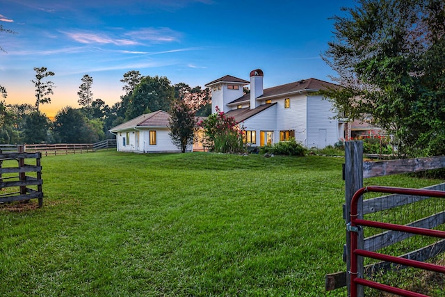 view of yard at dusk