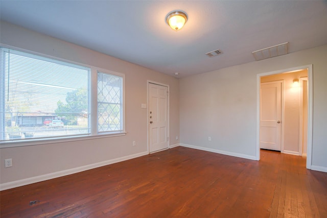 unfurnished room with dark hardwood / wood-style flooring