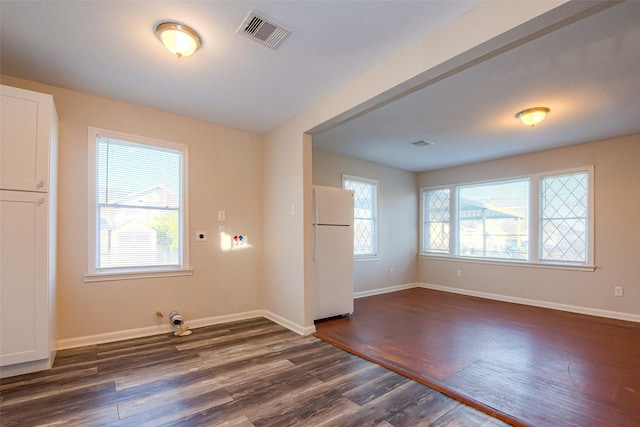 unfurnished room with dark wood-type flooring