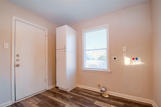 laundry area featuring hookup for an electric dryer, gas dryer hookup, and dark wood-type flooring