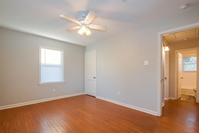 empty room with ceiling fan and hardwood / wood-style floors