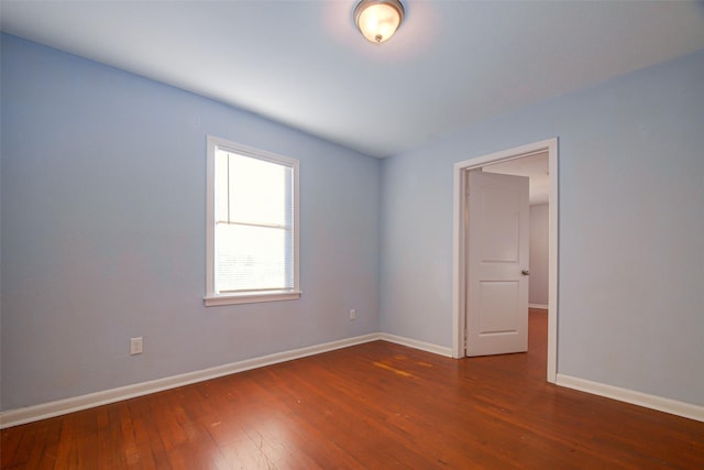 spare room with dark hardwood / wood-style floors