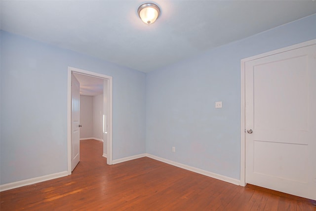 unfurnished room featuring dark hardwood / wood-style floors