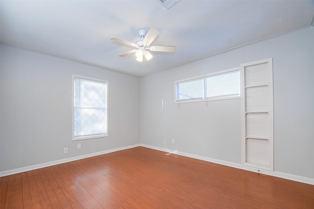 empty room with wood-type flooring and ceiling fan