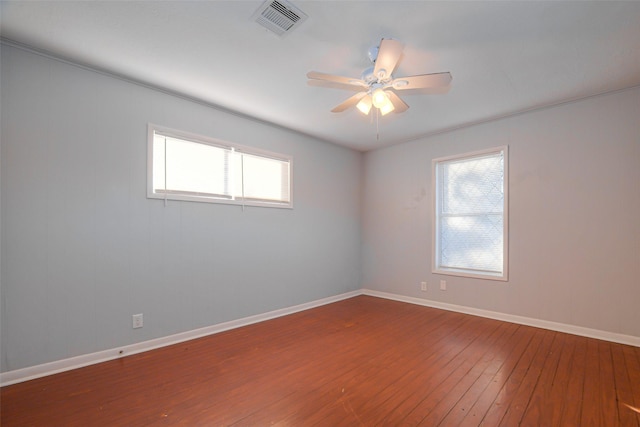 unfurnished room with hardwood / wood-style flooring, plenty of natural light, and ceiling fan