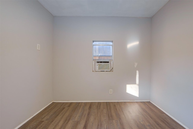 empty room with dark hardwood / wood-style flooring and cooling unit