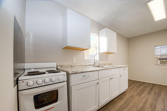 kitchen with white range with gas stovetop, cooling unit, wood-type flooring, sink, and white cabinetry