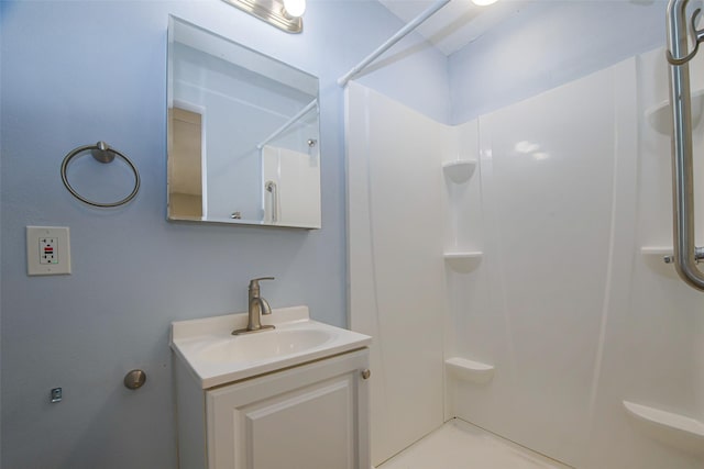 bathroom with a shower and vanity