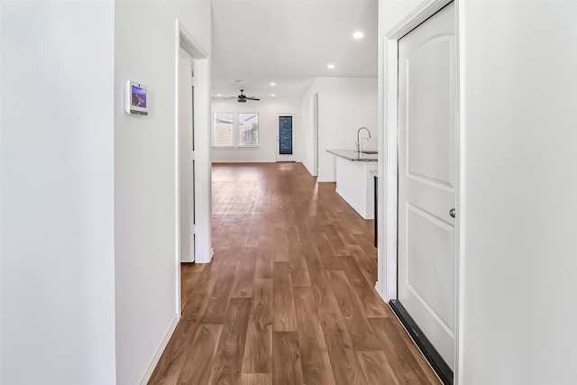 hallway with hardwood / wood-style floors