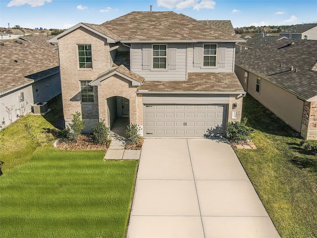 view of property with a front yard, central AC unit, and a garage