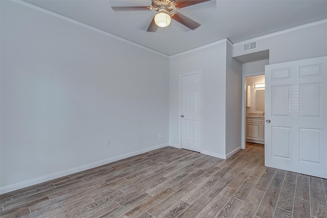 unfurnished bedroom featuring ceiling fan, light hardwood / wood-style floors, ornamental molding, and a closet