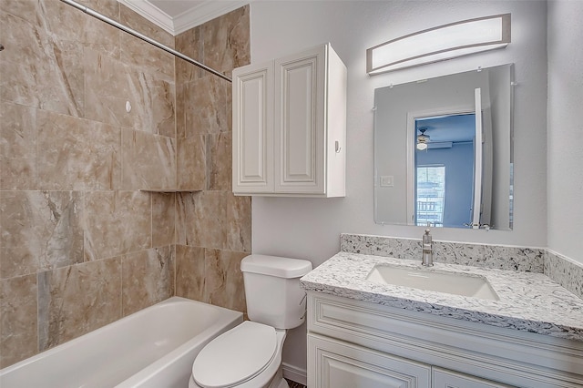 full bathroom featuring ceiling fan, washtub / shower combination, toilet, vanity, and ornamental molding