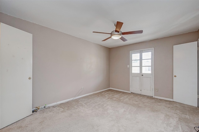 unfurnished room with ceiling fan and light carpet