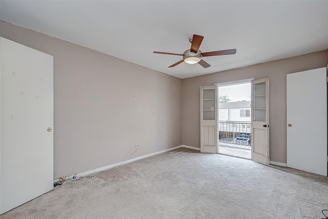 carpeted spare room with ceiling fan