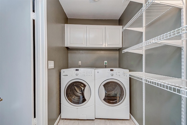 laundry area featuring separate washer and dryer and light tile patterned flooring