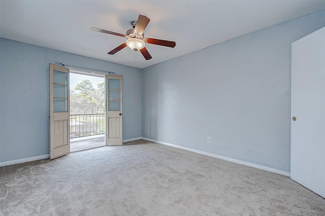 carpeted spare room featuring ceiling fan