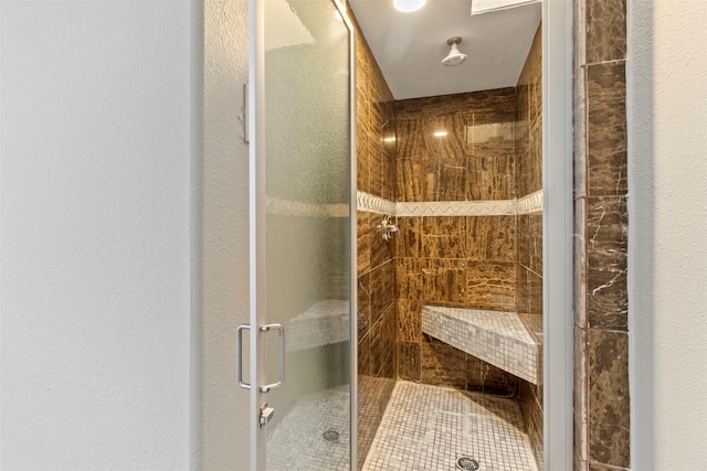 bathroom with a shower with door