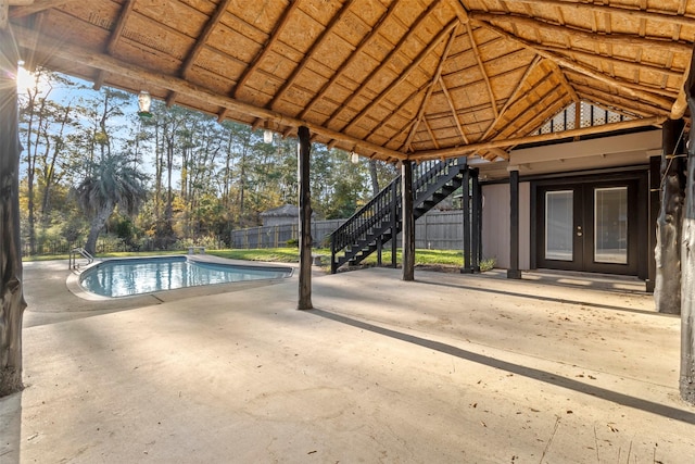 view of swimming pool featuring a patio area and french doors