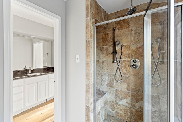 bathroom featuring vanity, a shower with shower door, and hardwood / wood-style flooring