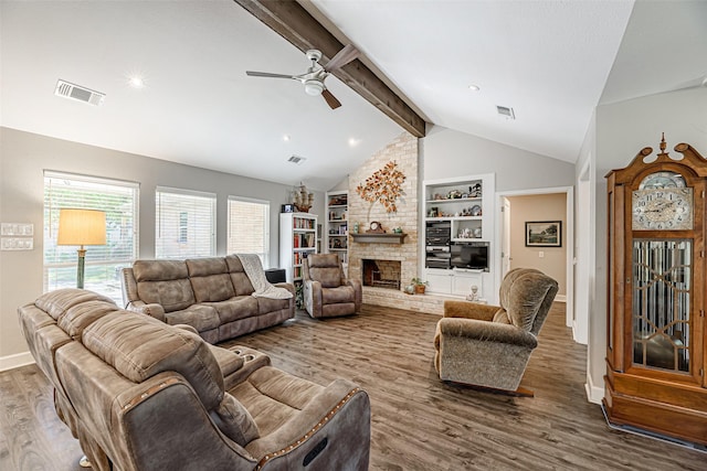 living room featuring a brick fireplace, built in shelves, ceiling fan, wood-type flooring, and vaulted ceiling with beams