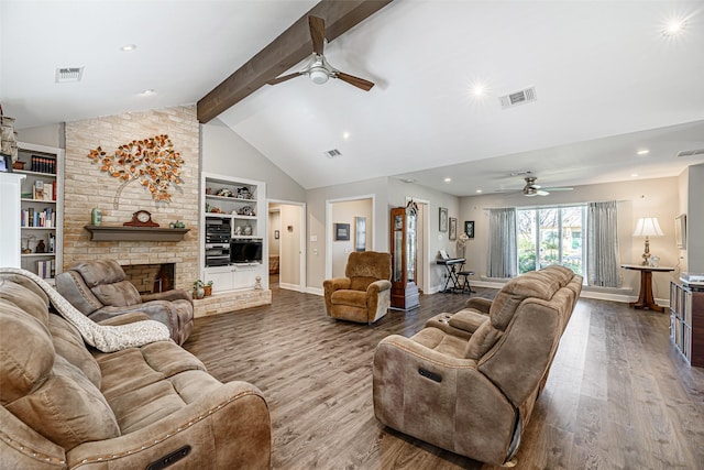 living room with ceiling fan, wood-type flooring, lofted ceiling with beams, built in features, and a fireplace