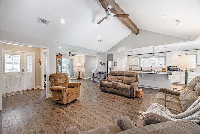 living room with ceiling fan, beamed ceiling, wood-type flooring, and high vaulted ceiling