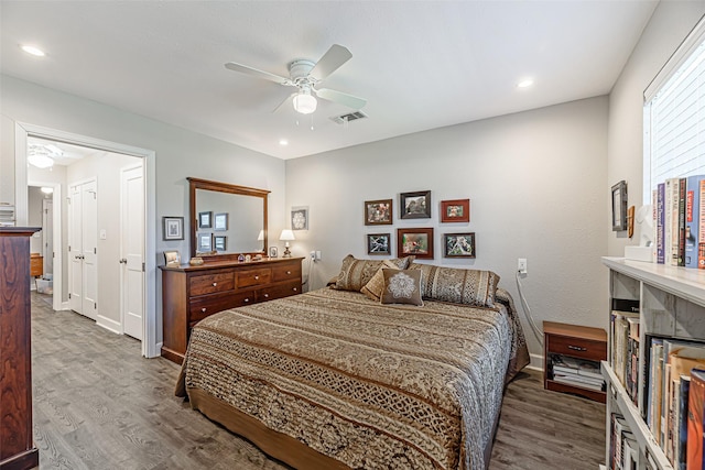 bedroom with ceiling fan and hardwood / wood-style floors