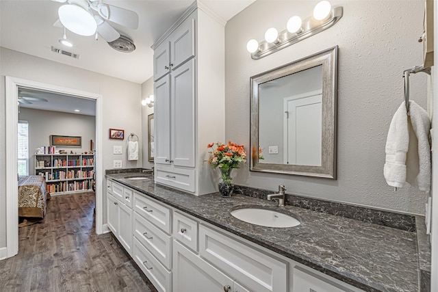 bathroom with vanity, hardwood / wood-style flooring, and ceiling fan