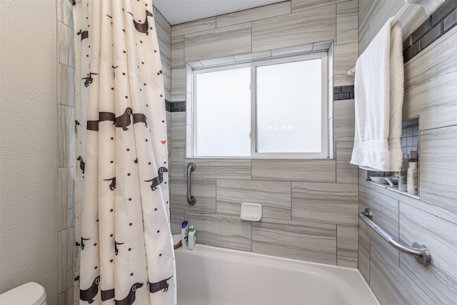 bathroom featuring shower / tub combo and a healthy amount of sunlight