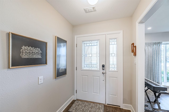 entrance foyer featuring a textured ceiling and hardwood / wood-style flooring