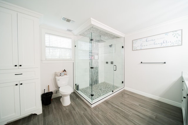 bathroom featuring toilet, wood-type flooring, ornamental molding, and walk in shower